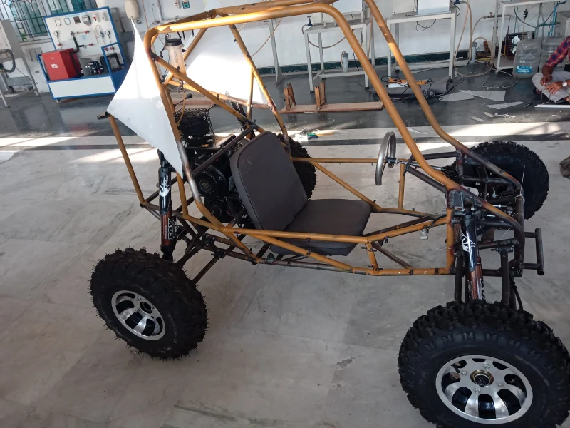 The team's yellow-framed off-road vehicle in the workshop.